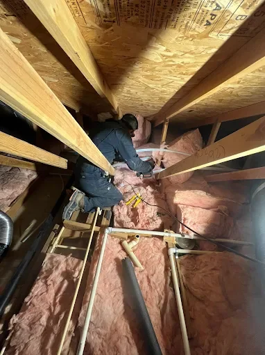 Bert's Mega Plumbing technician repairing a residential gas line in the San Fernando Valley with permit paperwork in hand